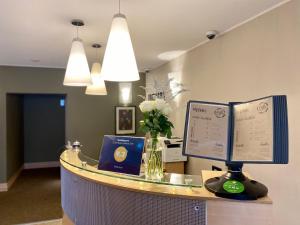 a reception desk with a computer on top of it at Hotel Eva in Perm