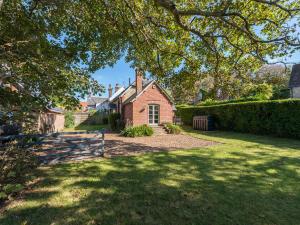 a red brick house with a gate in a yard at St Mary's Chapel in Wareham