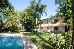 a resort with a swimming pool in front of a building at Samara Beach Hotel in Sámara