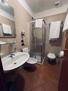 a bathroom with a sink and a shower and a toilet at Tenuta Re Ferdinando in Santa Maria Capua Vetere