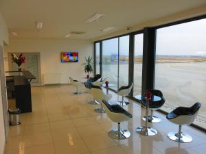 a waiting room at an airport with a row of chairs at Elmontex Air in Mošnov