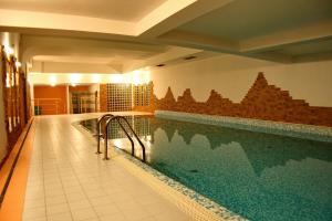 a swimming pool in a house with a swimming pool at Apartamenty Willa Radowid Zakopane in Zakopane
