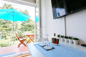 a room with a table with a blue umbrella at Beachfront Apartment Mala Tereza in Split