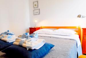 a bedroom with a bed with towels on it at Beachfront Apartment Mala Tereza in Split
