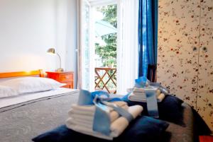 a bedroom with a bed with towels and a window at Beachfront Apartment Mala Tereza in Split