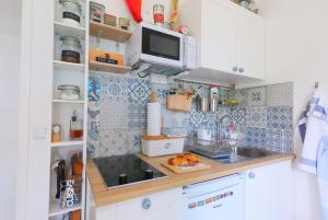 a small kitchen with a sink and a microwave at Beachfront Apartment Mala Tereza in Split