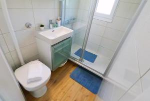 a bathroom with a toilet and a sink and a shower at Beachfront Apartment Mala Tereza in Split