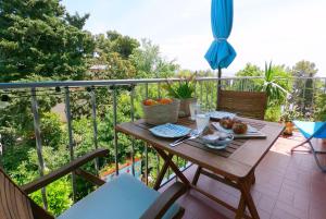 a table with a bowl of fruit on a balcony at Beachfront Apartment Mala Tereza in Split