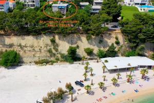 an aerial view of a beach with a sign on a cliff at Beachfront Apartment Mala Tereza in Split