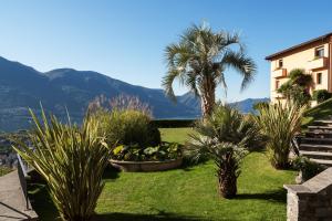 a garden filled with lots of plants and flowers at Villa Orselina - Small Luxury Hotel in Locarno
