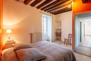 a bedroom with a large bed and a desk at Gîte de la Prévôté in Sergy