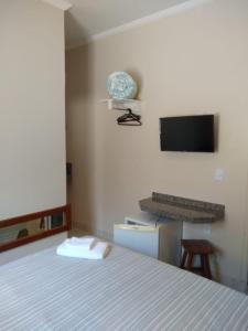 a bedroom with a bed and a keyboard and a monitor at Leme Plaza Hotel in Leme