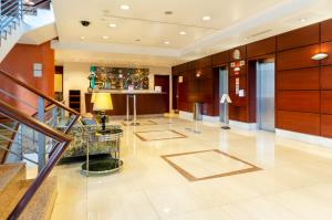 a lobby of a hotel with a staircase and a table at Hotel Marques De Pombal in Lisbon