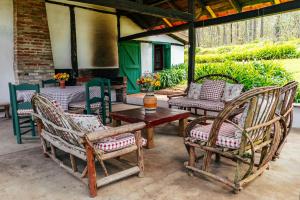 two chairs and a table on a patio at Villa Pajon Eco Lodge in Constanza