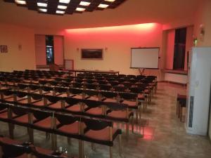 an empty lecture hall with chairs and a whiteboard at Apart Hotel Central Razgrad in Razgrad