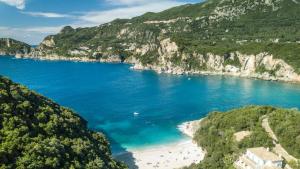 a view of a beach with people in the water at Amalia's House in Liapades +9 photos