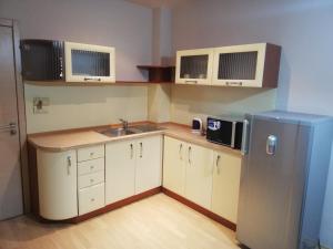 a small kitchen with a sink and a refrigerator at Apart Hotel Central Razgrad in Razgrad