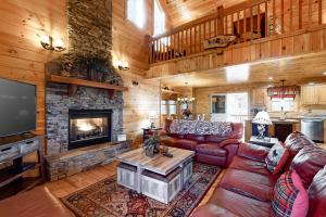 a living room with a couch and a fireplace at Bearfoot Lodge in Ellijay