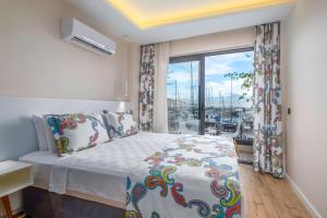 a bedroom with a bed and a large window at Ece Marina Suit in Fethiye