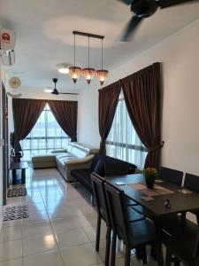 a living room with a table and a couch at A29 Benoni Garden Suites in Papar