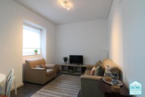 a living room with a couch and a table at Chez Nous - Guest House in Barreiro