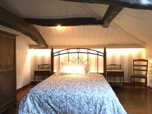 a bedroom with a bed with a blue comforter and two chairs at Hospedaje Albizabal HVI00405 in Amurrio