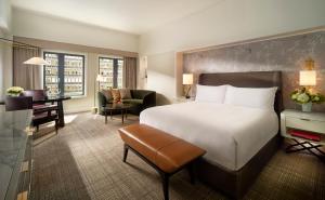 a hotel room with a bed and a living room at Mandarin Oriental Boston in Boston