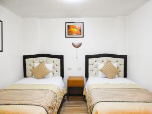 Postel nebo postele na pokoji v ubytování Hostal Encanto Machupicchu + 22 fotografií
