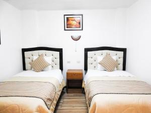 En eller flere senge i et værelse på Hostal Encanto Machupicchu