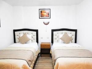 Postel nebo postele na pokoji v ubytování Hostal Encanto Machupicchu