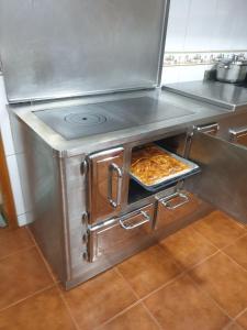 una estufa en una cocina con algo de comida. en MR alheira house, en Barcelos