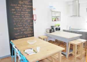 a kitchen with two tables and a chalkboard at Peneco Albufeira GuestHouse in Albufeira +44 photos