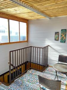 a room with a staircase and a table and chairs at Hostal Maria Casa in La Serena