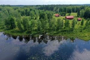 an aerial view of a house next to a lake at Holiday home Småland Gäddegölshult in Gäddegölshult