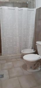 a bathroom with a toilet and a shower curtain at Inti Raymi in Maimará