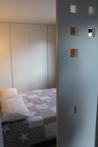 a bedroom with a bed with a white headboard at Casa Coltura in Bormio