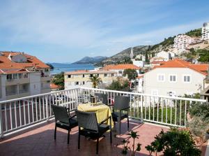 a patio with a table and chairs on a balcony at Apartments Tomy & Domy in Dubrovnik