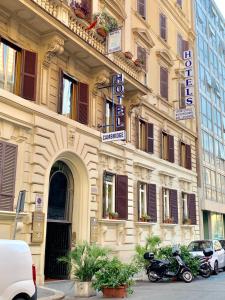 a building on a street with cars parked in front of it at Hotel Eurorooms in Rome