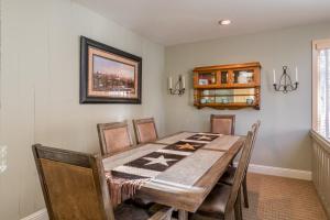 a dining room with a wooden table and chairs at Prospector 205 in Ketchum