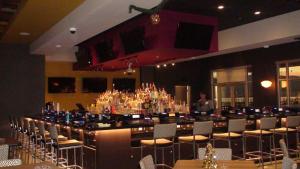 a large room with a bar with chairs and a man at Havasu Landing Resort and Casino in Havasu Lake