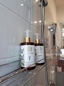 two bottles ofodorizers sitting on a shelf in a bathroom at CityComfort Hotel Kitay- Gorod in Moscow
