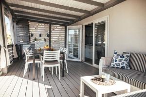 a living room with a couch and a table at Rasin Mobile Homes in Pakoštane