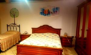 a bedroom with a bed and a tree on the wall at B & B Luoghi Antichi in Castrovillari