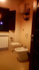 a bathroom with a toilet and a sink at B & B Luoghi Antichi in Castrovillari