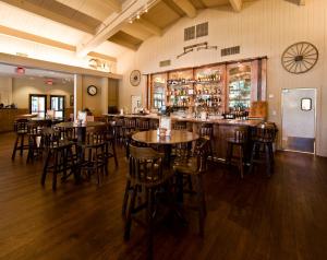 a restaurant with wooden tables and chairs and a bar at Colter Bay Village in Colter Bay Village