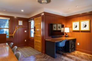 a home office with a desk and a television at Cedar Crest - Robin Cottage 6 in Homewood