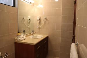 a bathroom with a sink and a shower at Suites Jardín Imperial in Guatemala +15 photos