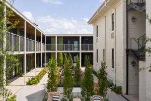 an exterior view of a building with a courtyard with trees at Bradford House in Oklahoma City