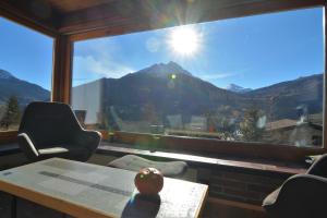 a room with a table and a view of a mountain at Haus Schwarz in Savognin