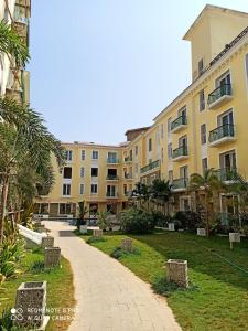 a walkway in front of a large building at Areia De Goa Luxury Condo in Arpora